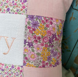 Peachy pink patchwork name cushion